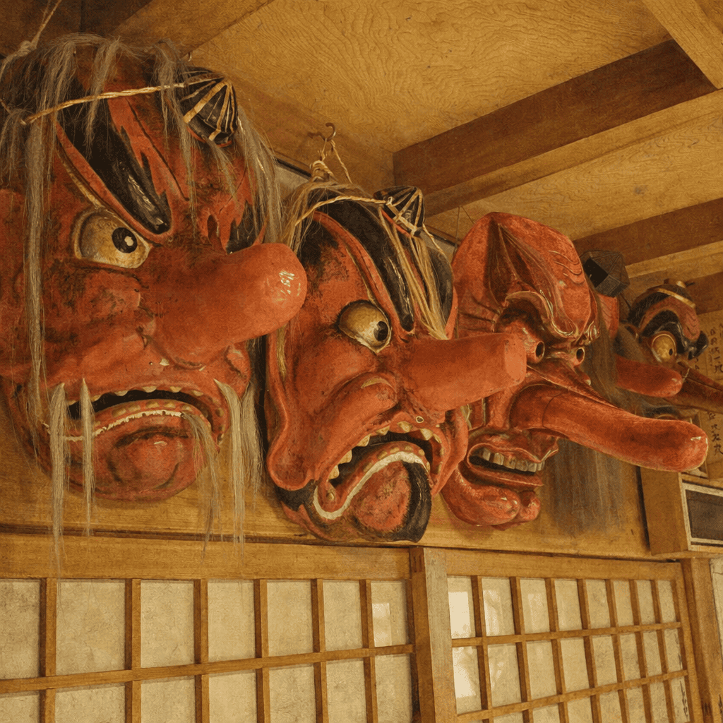 Tengu masks at Furumine Shrine — rows of fierce red-faced tengu staring down from the rafters
